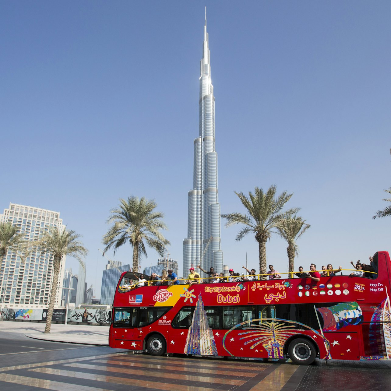 Experience Dubai from a unique viewpoint aboard the hop-on hop-off bus cruising by iconic landmarks like the Burj Khalifa while exploring the city's stunning sights at your own pace.